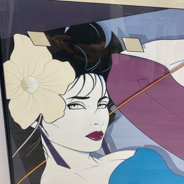 Framed Print of Woman in Aqua Top and Purple Pants by Patrick Nagel